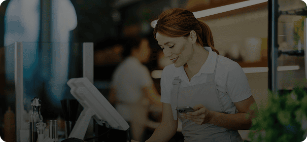 Woman using register in cafe