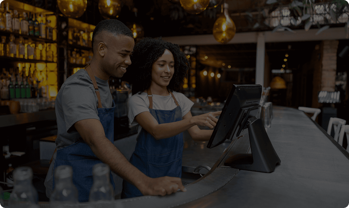 Bartenders using a touchscreen register