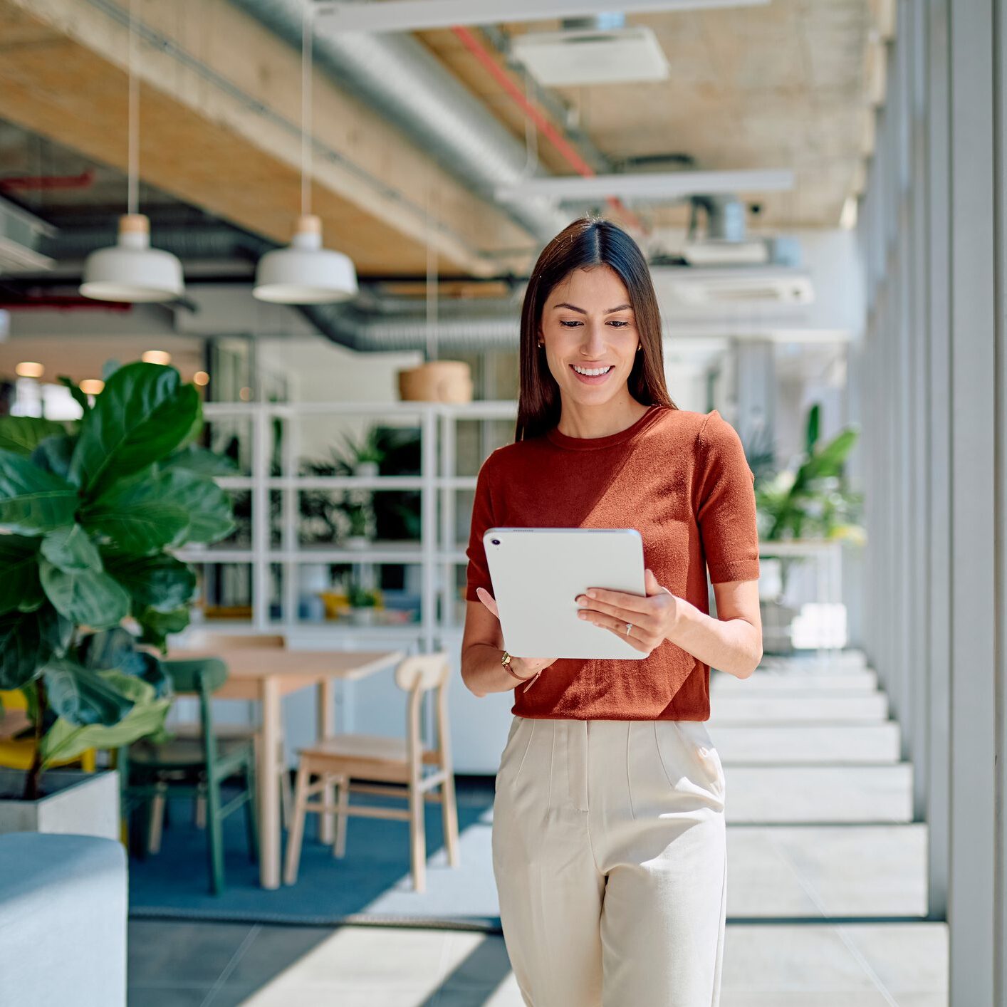 Woman using tablet in modern office.